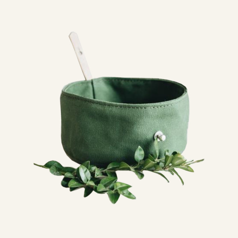 Green Folding Canvas Bowl, open, on an off-white background.
