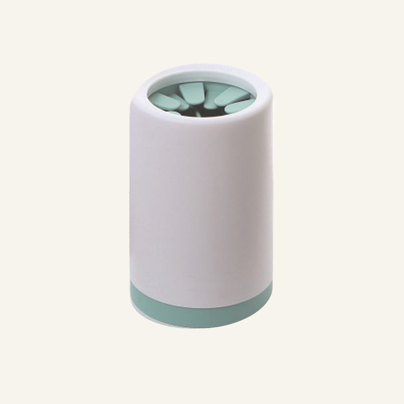 Going Kind Paw Cleaner in Green, white cup with mint-green base and cleaning insert.